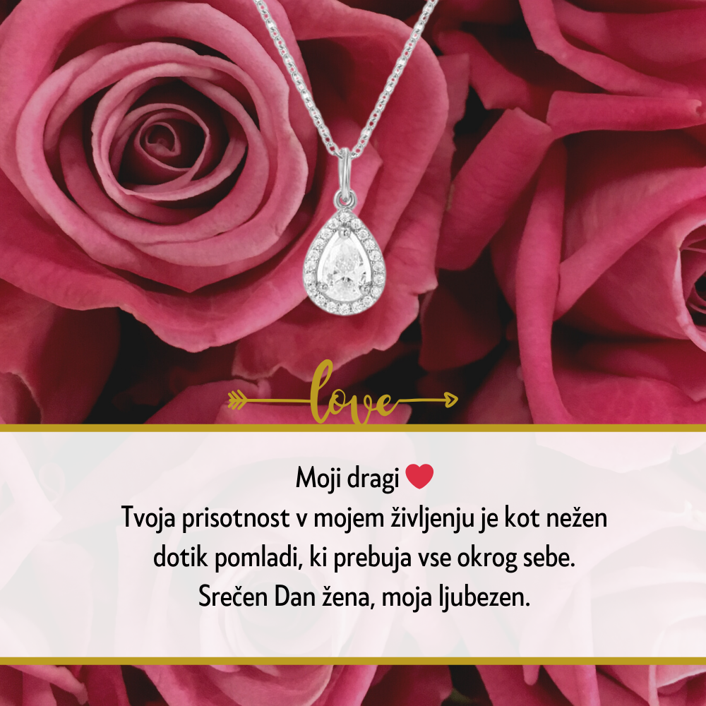 Personalizirana srebrna verižica z vgraviranim imenom in datumom, obdana z majhnimi kristali, kot idealno darilo za Dan žena. Elegantna darilna škatla na beli podlagi z rdečo vrtnico ob strani, simbolizira ljubezen in spoštovanje na poseben dan