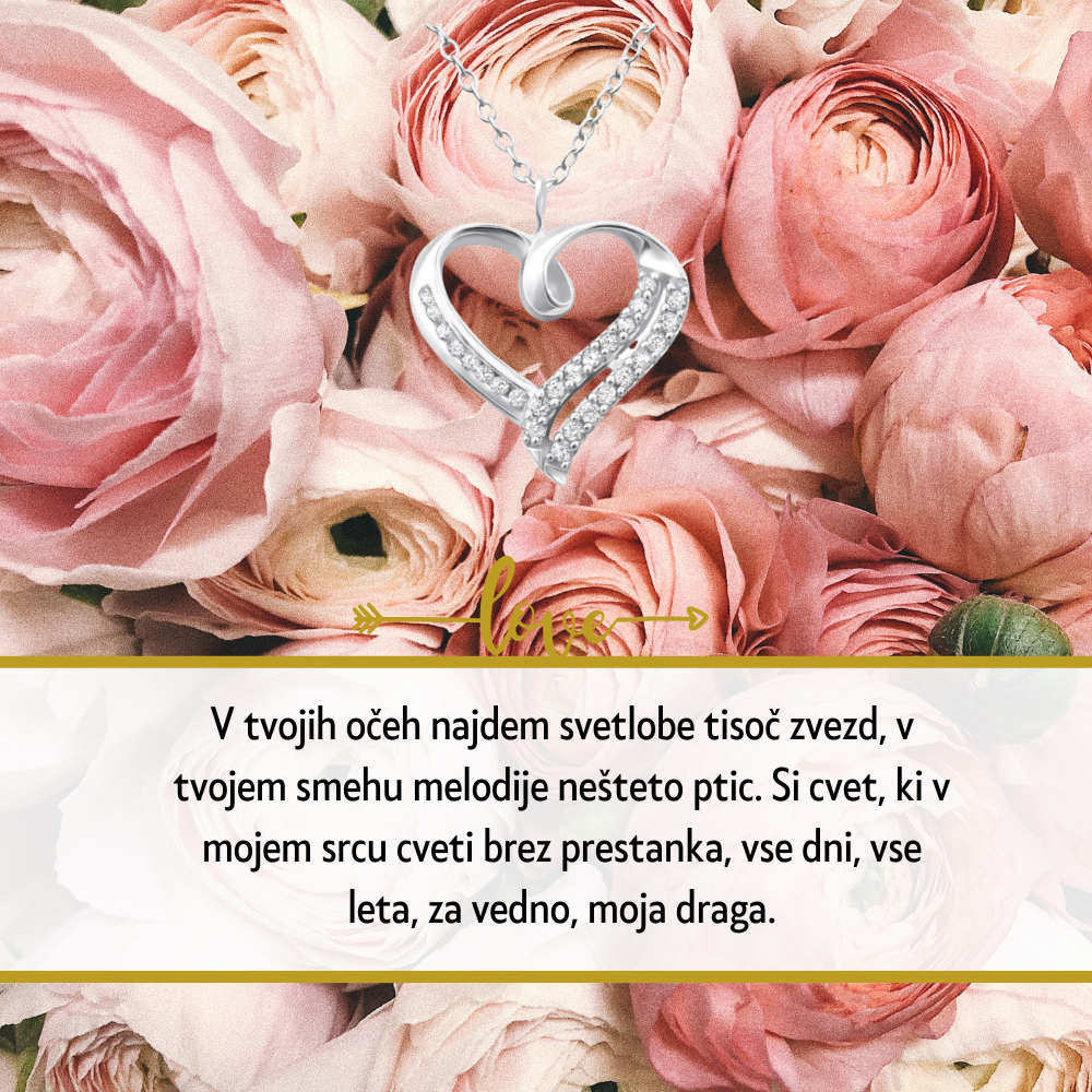 Personalizirana srebrna verižica z vgraviranim imenom in datumom, obdana z majhnimi kristali, kot idealno darilo za Dan žena. Elegantna darilna škatla na beli podlagi z rdečo vrtnico ob strani, simbolizira ljubezen in spoštovanje na poseben dan