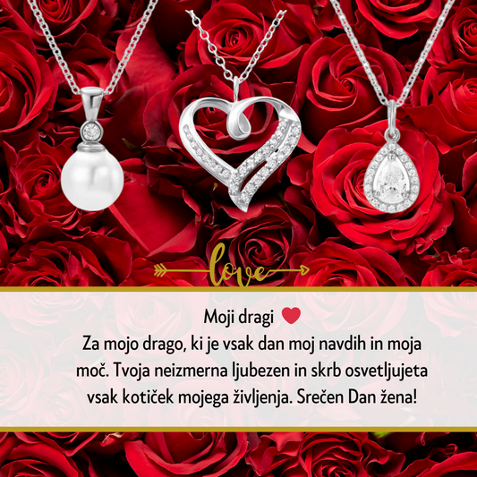 Personalizirana srebrna verižica z vgraviranim imenom in datumom, obdana z majhnimi kristali, kot idealno darilo za Dan žena. Elegantna darilna škatla na beli podlagi z rdečo vrtnico ob strani, simbolizira ljubezen in spoštovanje na poseben dan